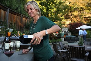 Photo of Valerie Kelleher pouring Kelleher wine